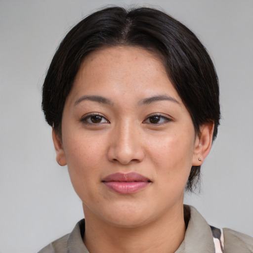Joyful asian young-adult female with medium  brown hair and brown eyes