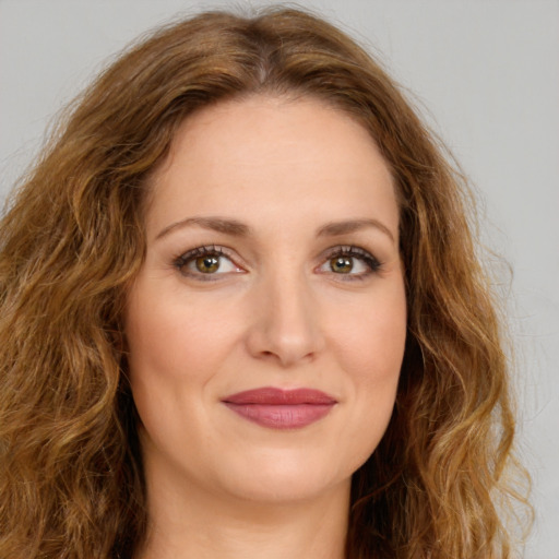 Joyful white young-adult female with long  brown hair and green eyes