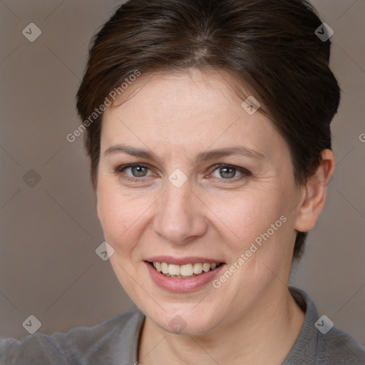 Joyful white adult female with short  brown hair and brown eyes