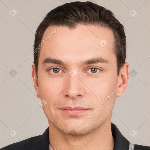 Joyful white young-adult male with short  brown hair and grey eyes