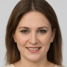 Joyful white young-adult female with long  brown hair and green eyes