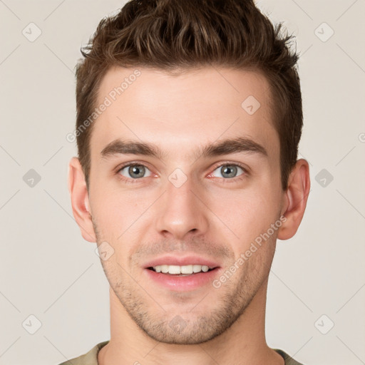 Joyful white young-adult male with short  brown hair and grey eyes