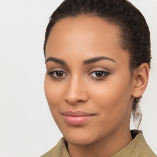 Joyful latino young-adult female with long  brown hair and brown eyes