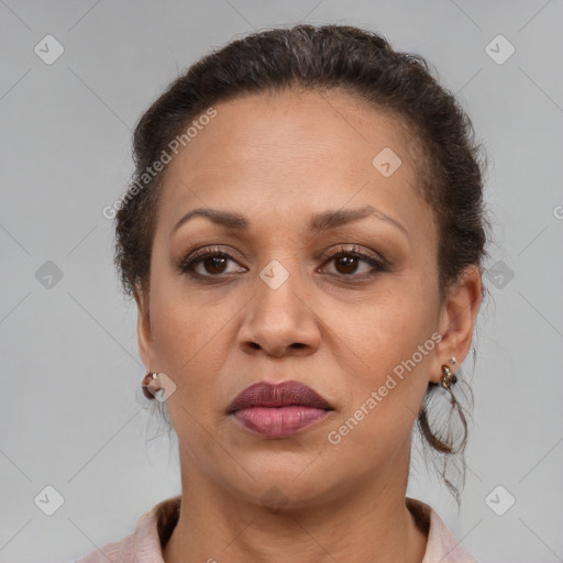 Joyful latino adult female with medium  brown hair and brown eyes