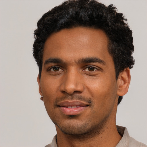 Joyful black young-adult male with short  black hair and brown eyes