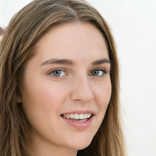 Joyful white young-adult female with long  brown hair and green eyes