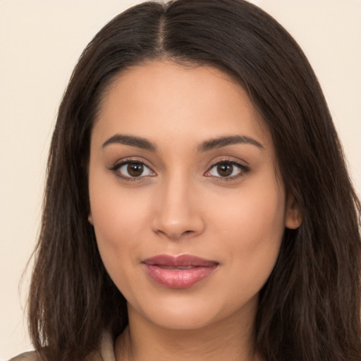 Joyful latino young-adult female with long  brown hair and brown eyes