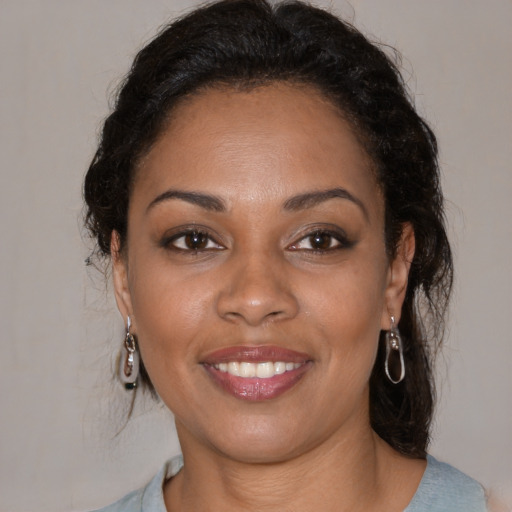 Joyful black young-adult female with medium  brown hair and brown eyes