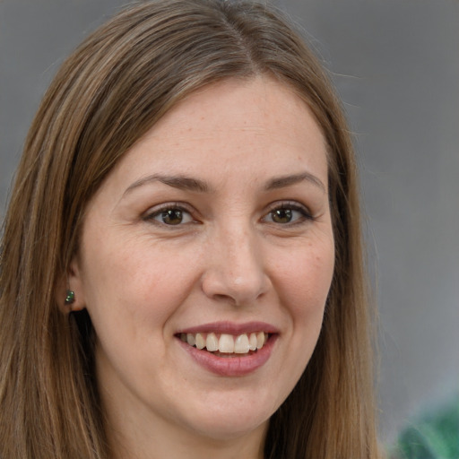 Joyful white young-adult female with long  brown hair and brown eyes