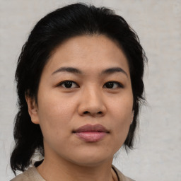 Joyful asian young-adult female with medium  brown hair and brown eyes