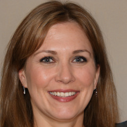 Joyful white adult female with medium  brown hair and brown eyes