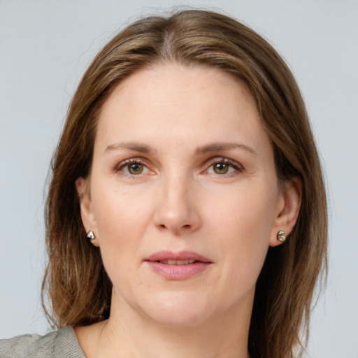 Joyful white young-adult female with medium  brown hair and blue eyes