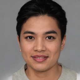 Joyful asian young-adult male with short  black hair and brown eyes