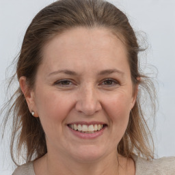 Joyful white adult female with medium  brown hair and grey eyes