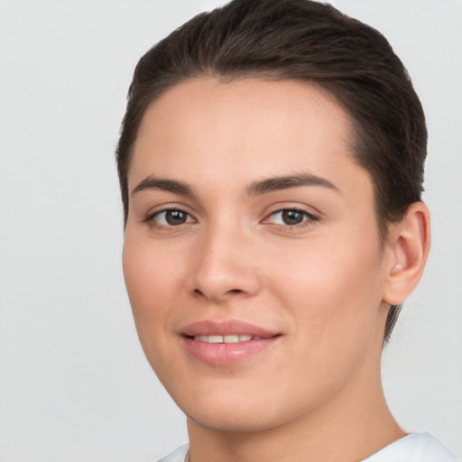 Joyful white young-adult female with short  brown hair and brown eyes