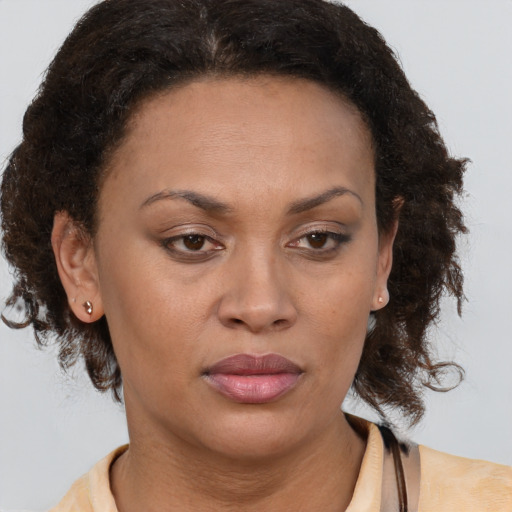 Joyful black adult female with medium  brown hair and brown eyes