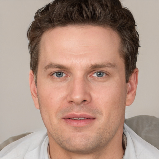 Joyful white adult male with short  brown hair and grey eyes