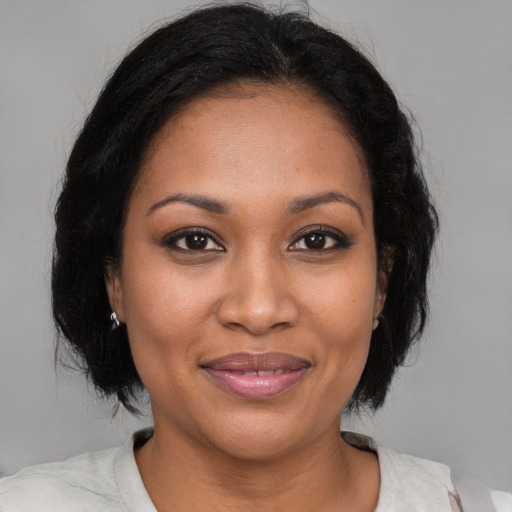 Joyful black young-adult female with medium  brown hair and brown eyes