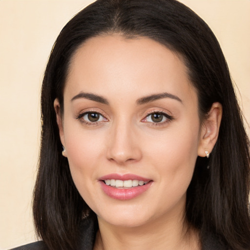 Joyful white young-adult female with long  black hair and brown eyes