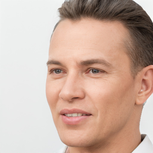 Joyful white adult male with short  brown hair and brown eyes