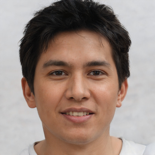 Joyful asian young-adult male with short  brown hair and brown eyes