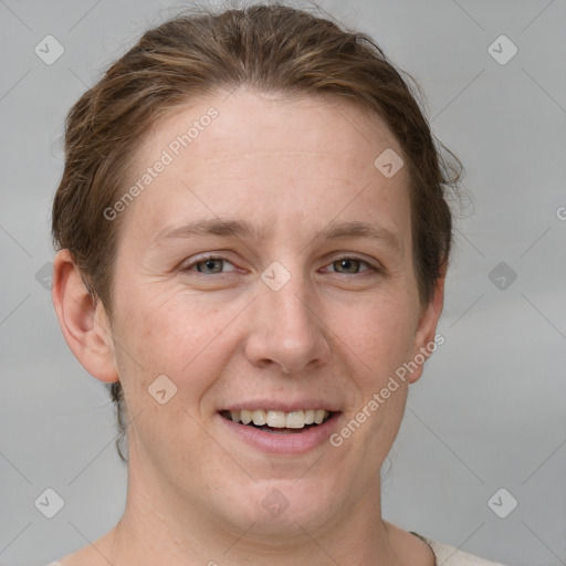 Joyful white adult female with short  brown hair and grey eyes