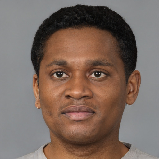 Joyful black young-adult male with short  brown hair and brown eyes