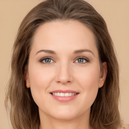 Joyful white young-adult female with long  brown hair and green eyes