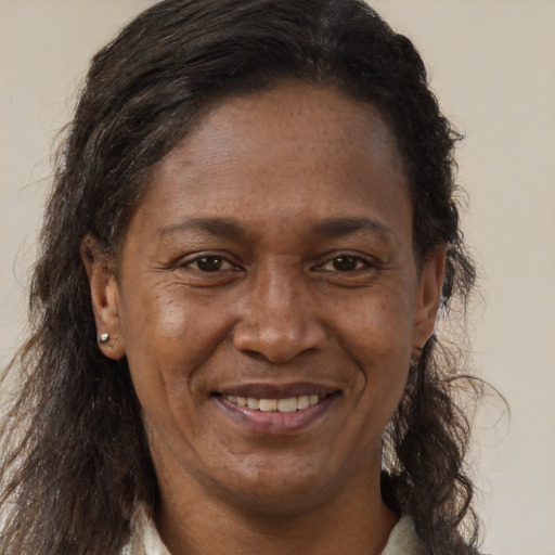 Joyful black adult female with short  brown hair and brown eyes