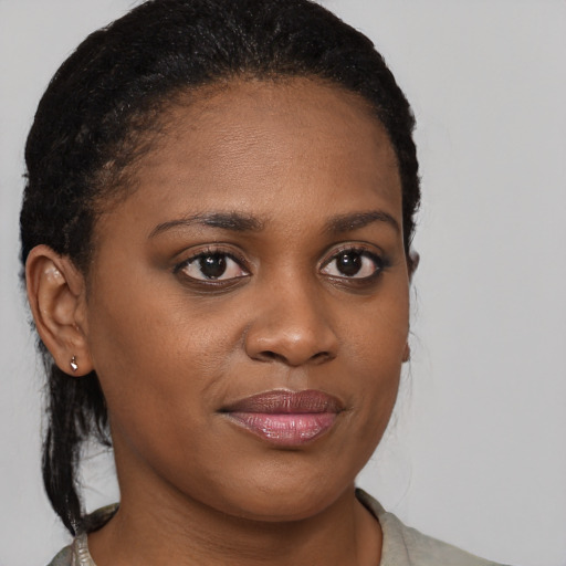 Joyful black young-adult female with medium  brown hair and brown eyes