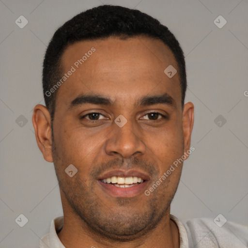 Joyful black young-adult male with short  brown hair and brown eyes