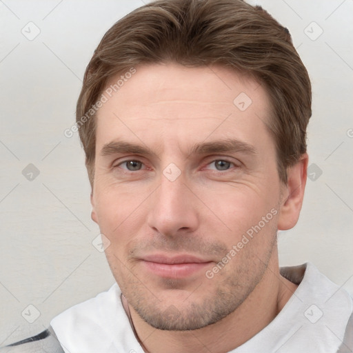 Joyful white young-adult male with short  brown hair and grey eyes