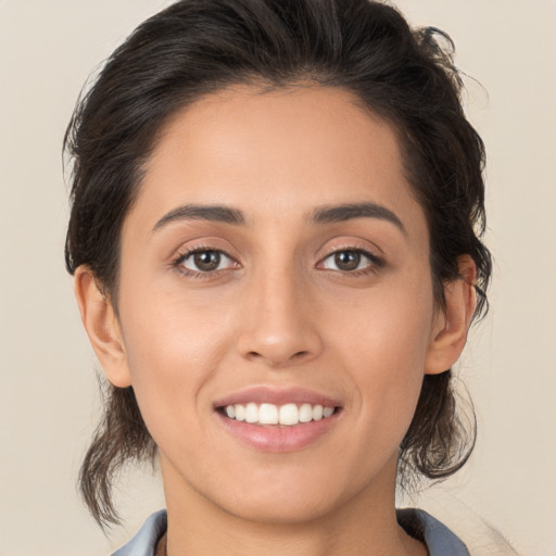 Joyful white young-adult female with medium  brown hair and brown eyes