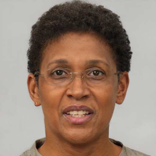 Joyful black adult female with short  brown hair and brown eyes