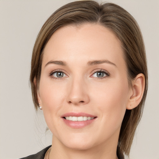 Joyful white young-adult female with medium  brown hair and grey eyes