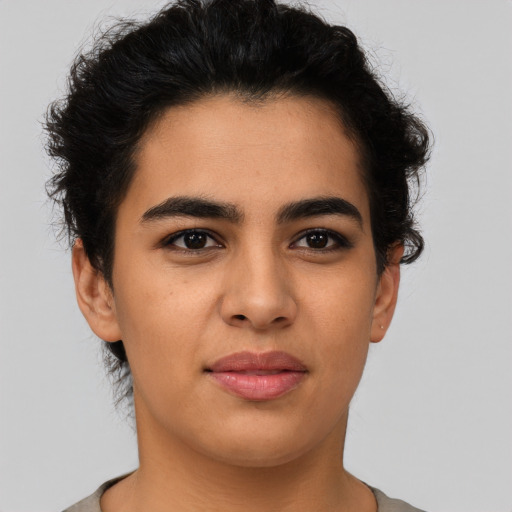 Joyful latino young-adult female with short  brown hair and brown eyes