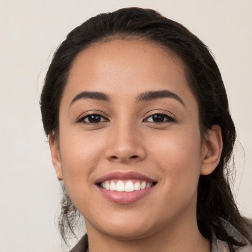 Joyful white young-adult female with long  black hair and brown eyes