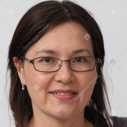 Joyful white adult female with long  brown hair and grey eyes