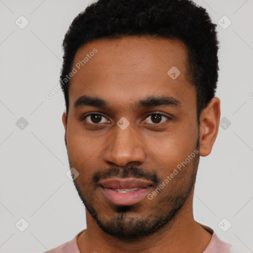 Joyful black young-adult male with short  black hair and brown eyes