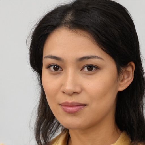 Joyful asian young-adult female with long  brown hair and brown eyes