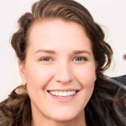 Joyful white young-adult female with long  brown hair and blue eyes