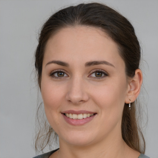 Joyful white young-adult female with long  brown hair and grey eyes