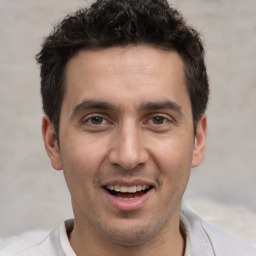 Joyful white adult male with short  brown hair and brown eyes