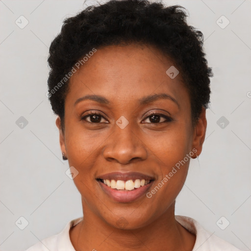 Joyful black young-adult female with short  black hair and brown eyes