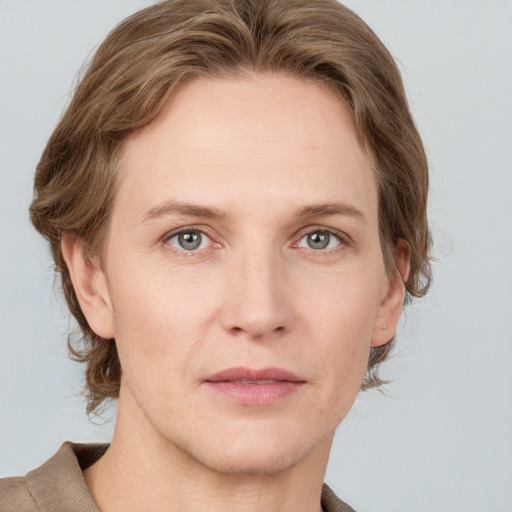 Joyful white adult female with medium  brown hair and grey eyes