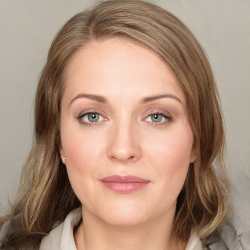 Joyful white young-adult female with medium  brown hair and blue eyes