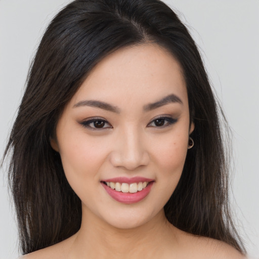 Joyful asian young-adult female with long  brown hair and brown eyes