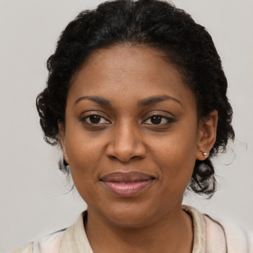 Joyful black young-adult female with medium  brown hair and brown eyes