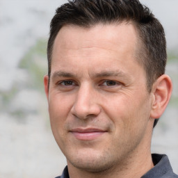 Joyful white adult male with short  brown hair and brown eyes