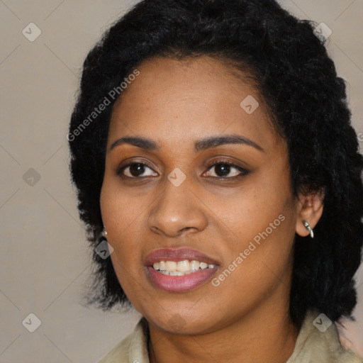 Joyful black young-adult female with long  black hair and brown eyes